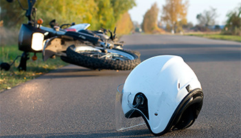 Photo of helmet and motorcycle on road